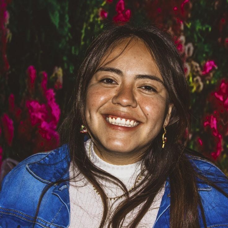 Riya Kapoor, Lead Design Curator at Verdant & Vine, reviewing corporate floral arrangements